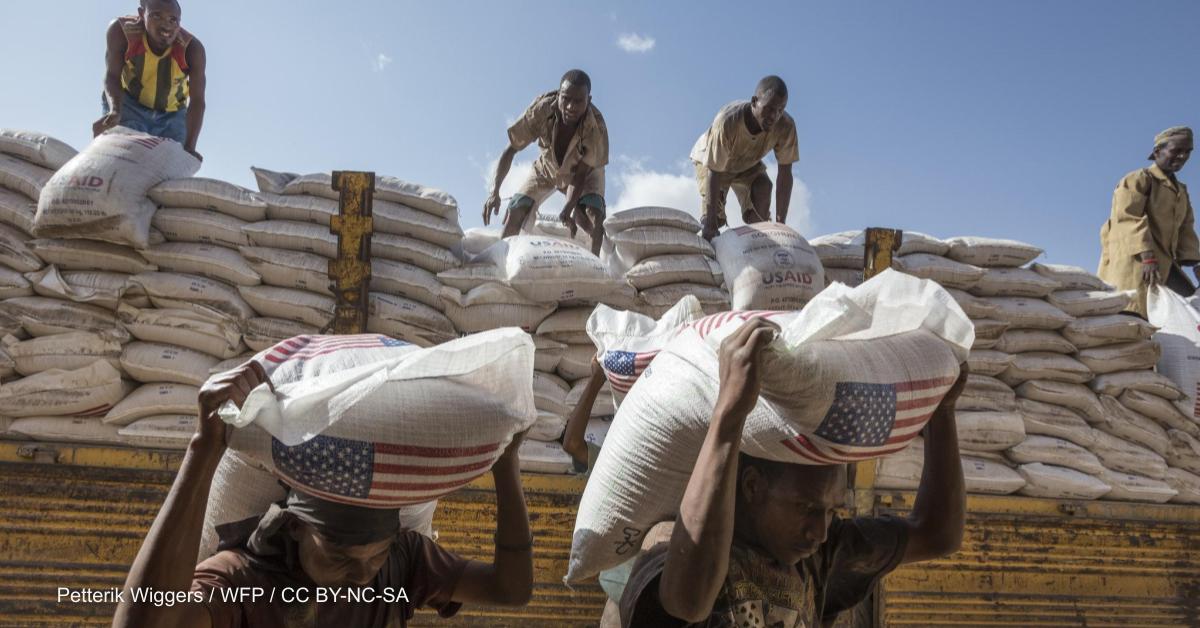 Workers offload sorghum bags donated by USAID into a warehouse in Jijiga, Ethiopia, to be distributed by WFP..