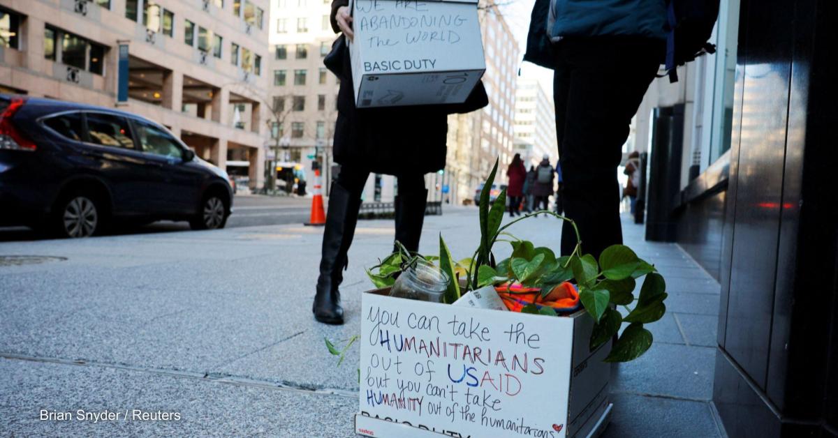 Recently fired USAID staff leave work during a send-off by former USAID staffers and supporters, outside USAID offices in Washington, D.C.