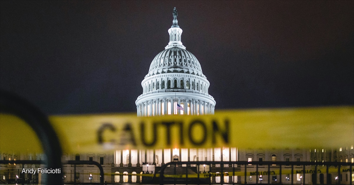 A caution tape in front of the U.S.
 Capitol building taken at night.
